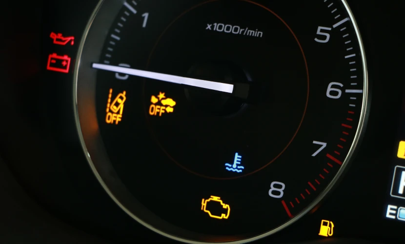 A car dashboard with many warning lights alight